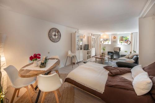 a bedroom with a bed and a table and a living room at MarEwa 80 qm apartment in Mechernich
