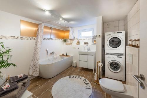 a bathroom with a washing machine and a washer at MarEwa 80 qm apartment in Mechernich