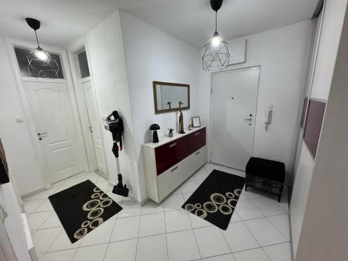 a white bathroom with a sink and a mirror at Neretva Paradise Mostar in Mostar