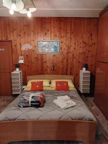 a bedroom with a large bed with wooden walls at Casa della Pace by Pinuccia in Roccaspinalveti
