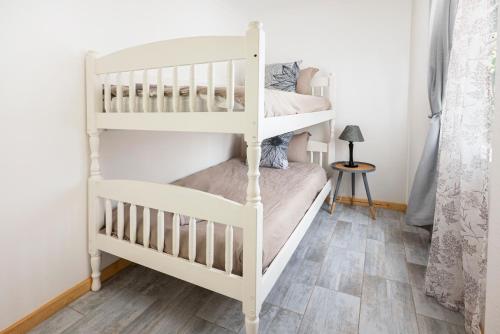 a white bunk bed in a room with a floor at Die Kant - Hooggety in George