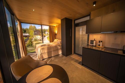 a room with a bed and a kitchen with a view at Escape - Bollnäs in Bollnäs