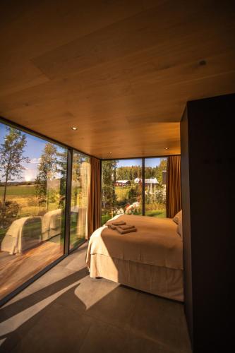 a bedroom with a bed and a large window at Escape - Bollnäs in Bollnäs