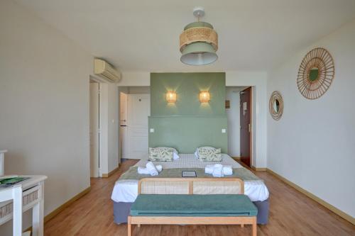 a bedroom with a bed with a green wall at "Cap Riviera" Hotel & Restaurant Saint Aygulf in Saint-Aygulf