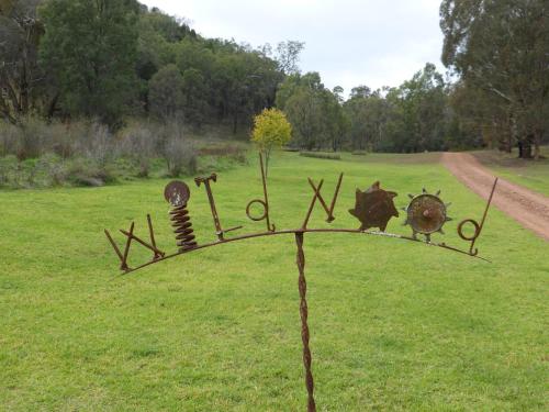 a metal object in the middle of a field at Wildwood Guesthouse in Mudgee