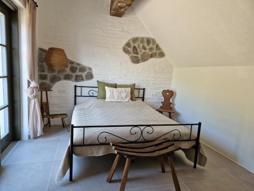 a bedroom with a large bed in a room at Bagolyvölgy Tulkó Ház in Balatonhenye