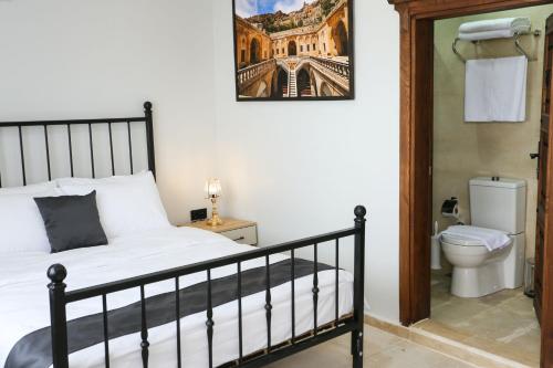 a bedroom with a bed and a toilet at The Castle İnn in Mardin