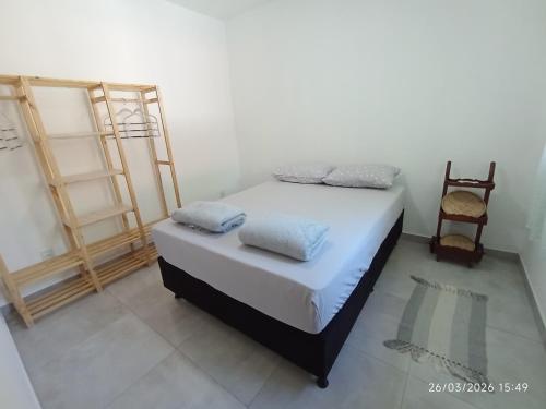 a bedroom with a bed with two pillows on it at Casa Lego Paraty in Paraty