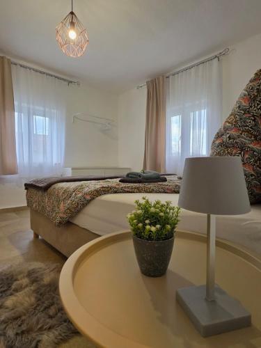 a bedroom with a bed and a table with a lamp at Velebitska Vila in Gračac