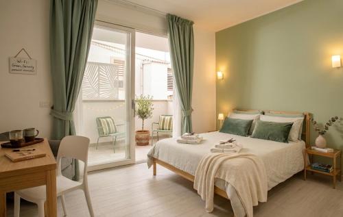 a bedroom with a bed and a table and chairs at Madau's House Exclusive Apartments in Olbia