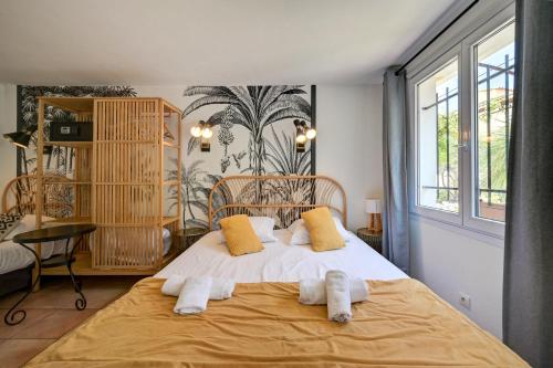 a bedroom with a large bed with towels on it at "Cap Riviera" Hotel & Restaurant Saint Aygulf in Saint-Aygulf