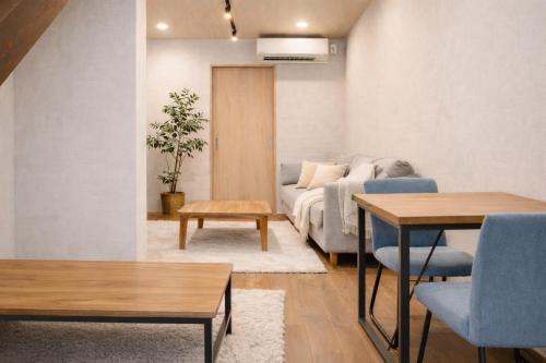 a living room with a couch and a table at Kyobashi house Entire house for rentー 京橋一軒家完全貸切 in Osaka