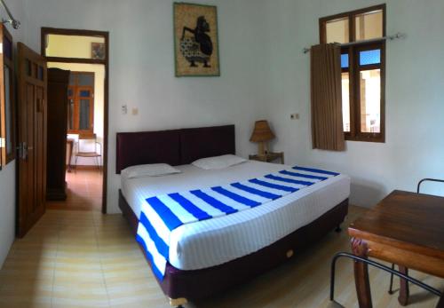 Postel nebo postele na pokoji v ubytování Mini Tiga Homestay