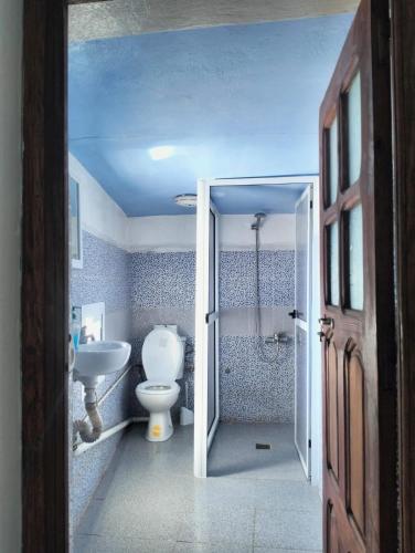 a bathroom with a toilet and a sink at Dar Bleu Pearl in Chefchaouen