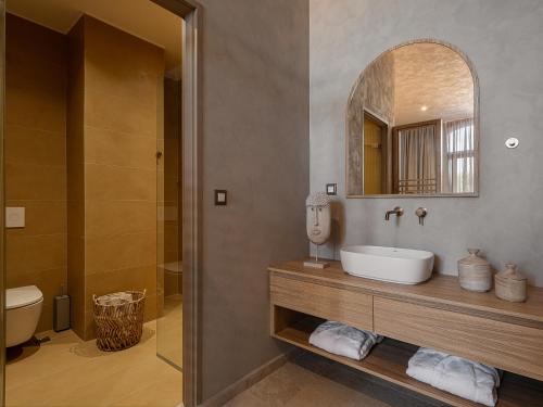 a bathroom with a sink and a mirror at Hestia Boutique - Renovated Rooms Just Steps from the Beach in Agia Marina Nea Kydonias