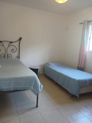 a bedroom with two beds and a window at Duplex Los Araujos in Yerba Buena
