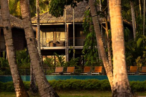 a resort with a swimming pool and palm trees at Tilar Siro Andamans - A CGH Earth Experience in Havelock Island