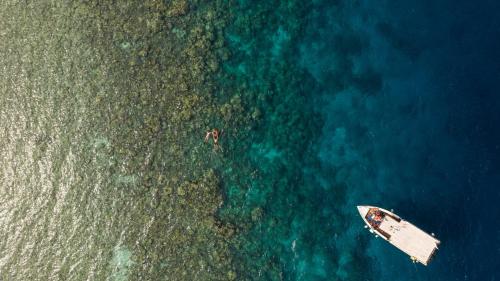 an aerial view of a boat in the ocean at Tilar Siro Andamans - A CGH Earth Experience in Havelock Island