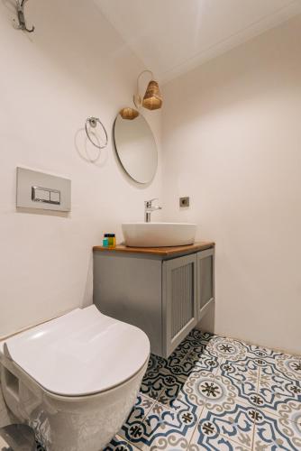 a bathroom with a white toilet and a sink at Riserva Urla in Urla
