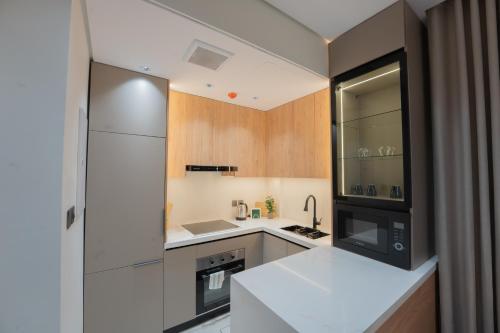 a kitchen with a white refrigerator and a sink at Luxury & Modern Brand New Family Apartments in Medina