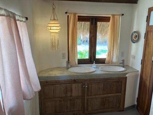 a bathroom with two sinks and a window at Riva Boutique Resort Koh Chang in Ko Chang