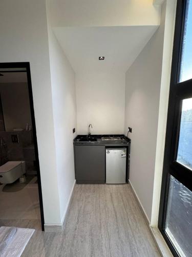 a kitchen with a sink and a counter in a room at فندق جديل2 - Jadeel Hotel 2 in Al Khobar