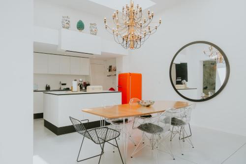 a kitchen with a table and chairs and a mirror at Luxury loft with private parking in Liège