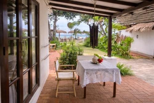 a table and chairs on a patio with a view of the ocean at Riva Boutique Resort Koh Chang in Ko Chang