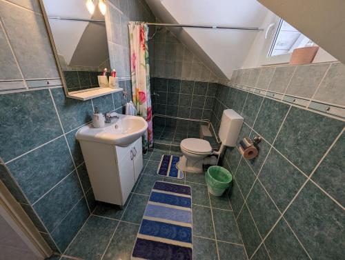 a small bathroom with a sink and a toilet at Peste Vale in Poşaga de Sus