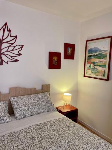 a bedroom with a bed and a picture on the wall at La Foglia in Abbadia San Salvatore