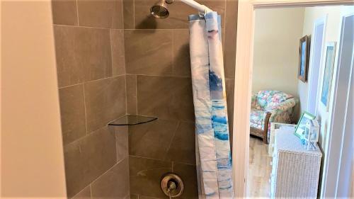 a shower with a shower curtain in a bathroom at Sail Away in Cape May Point