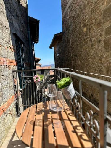 a wooden table on the balcony of a building at La Foglia in Abbadia San Salvatore