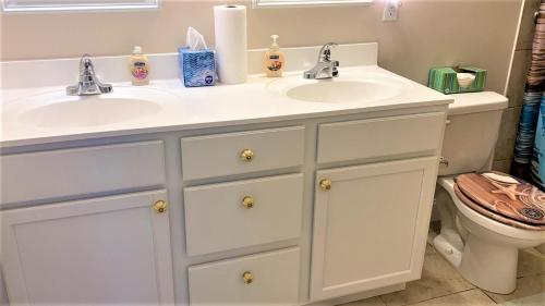 a bathroom with two sinks and a toilet at Seamans Folly On Broad in Cape May