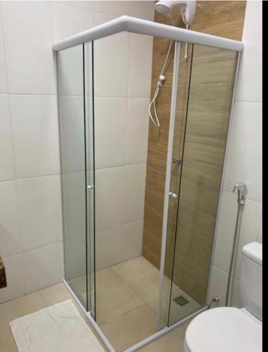 a glass shower in a bathroom with a toilet at Pousada le sorelle in Rosário do Sul
