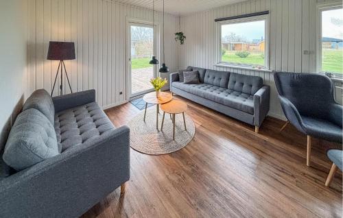 a living room with two couches and a table at Cozy Home In Sydals With Sauna in Skovby