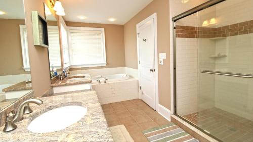 a bathroom with a tub and a sink and a shower at 209 Congress Street in Cape May