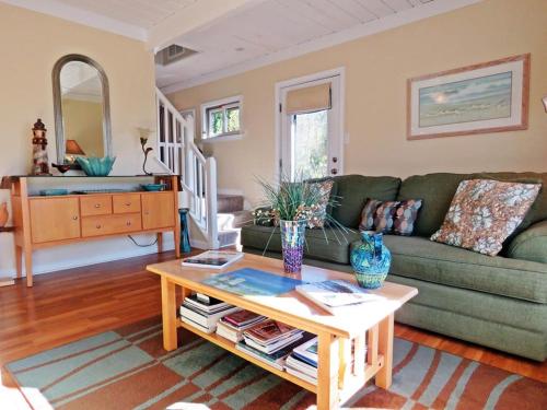 a living room with a green couch and a coffee table at Lily Pad Lake Views in Cape May Point