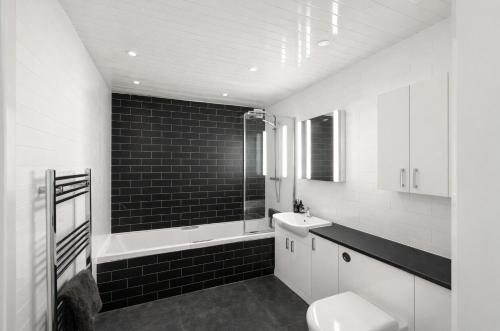 a black and white bathroom with a toilet and a sink at Taigh Oisean 4 Birnam Place Pitlochry in Pitlochry