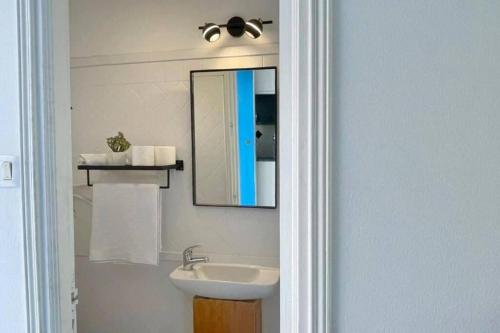 a bathroom with a sink and a mirror at Lappartement Pied dans leau in Douar el Hafey