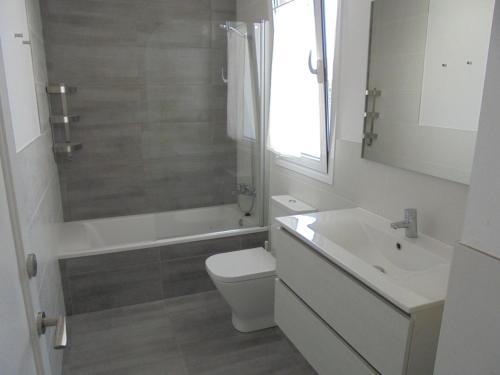 a bathroom with a toilet and a sink and a shower at Villa Tord Massot 11 in Ciutadella