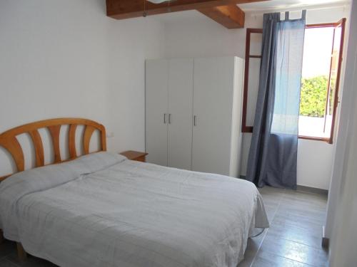 a bedroom with a bed and a window at Villa Tord Massot 11 in Ciutadella