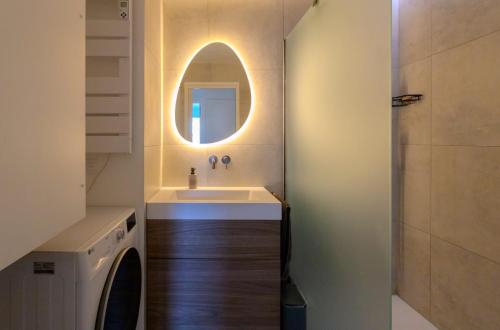 a bathroom with a sink and a mirror at Le Clos de Vallaurias in Vallauris