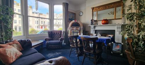 a living room with a couch and a table and a fireplace at Marine View in Brighton & Hove