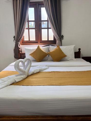 a large bed with a heart decoration on it at Regal Montara in Nuwara Eliya