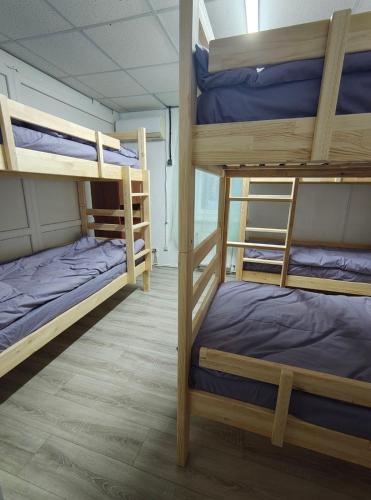 a room with three bunk beds in it at Ліза in Irpin