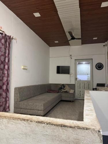a living room with a couch in a room at hotel apni haveli in Mandsaur