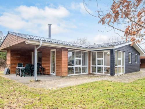 a home with a large patio and a house at 8 person holiday home in Blåvand in Blåvand