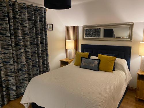 a bedroom with a bed with yellow pillows at The Well Bed & Breakfast in Clonakilty