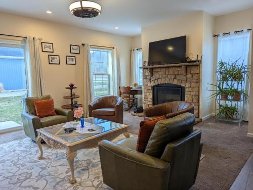 a living room with couches and a fireplace at Spacious Entire home close to HoliMont and Village in Ellicottville