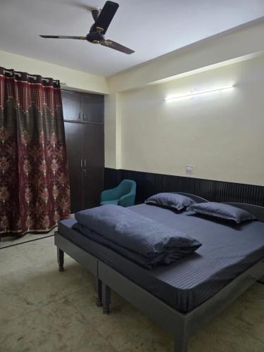 a bedroom with a bed and a ceiling fan at Gitanjali luxury in New Delhi